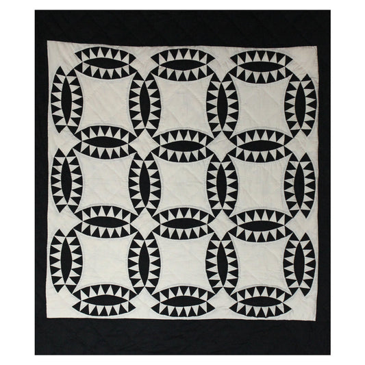 Patch Magic’s Coal Wedding Ring Quilt - This coal black rings with white feathers adorn this quilt having a white background and black border. It is 100% Cotton shell and hand layered organic cotton fill. It is hand quilted and hand layered for a unique soft touch and warmth.